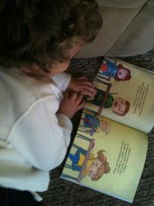 Here’s little Logan reading the inside of WHAT DO YOU WANT TO BE?