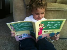 Little Logan reading WHAT DO YOU WANT TO BE?